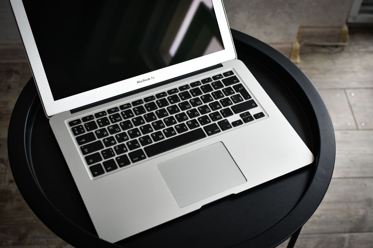 why-choose-us A stylish laptop sits elegantly on a black round table in an indoor setting, ideal for tech and workspace themes.