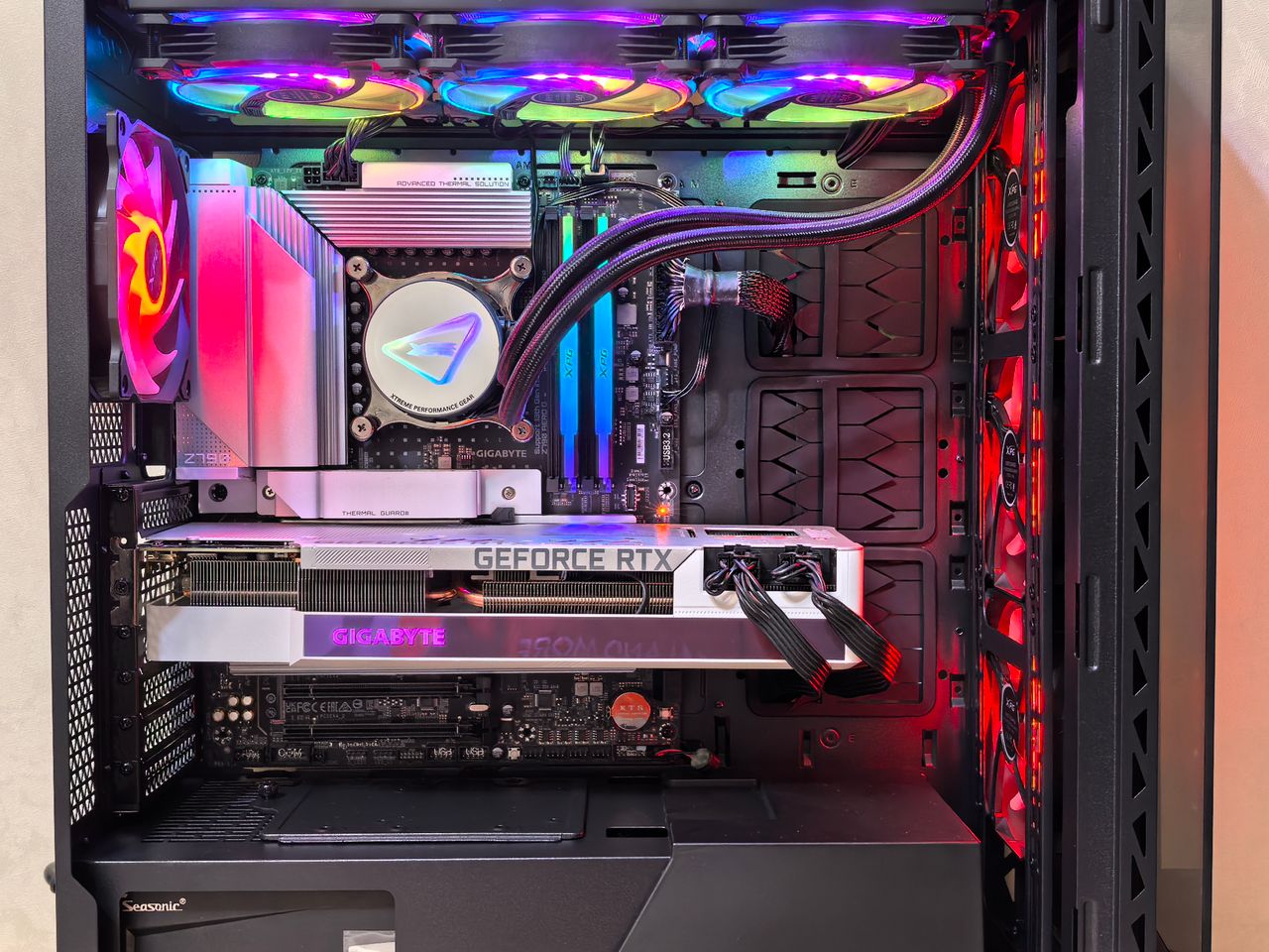 gallery-5 Inside view of a high-performance gaming PC showcasing components and vibrant RGB lighting.
