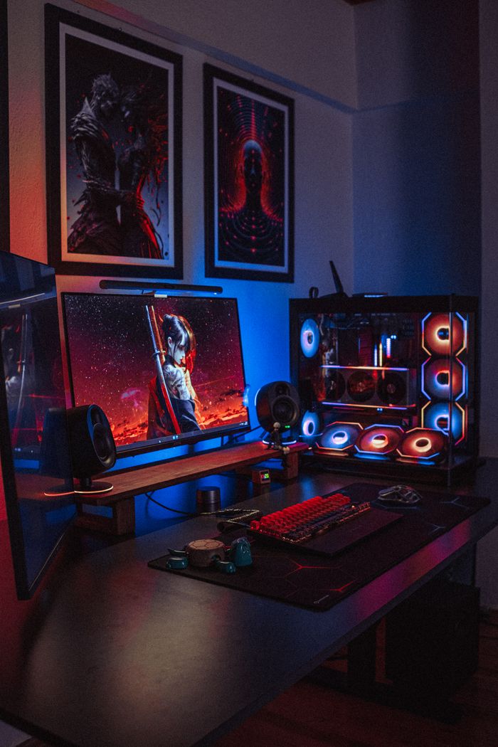 our-services-1 A vibrant RGB gaming setup featuring dual monitors, a custom PC, and backlit keyboard in a dimly lit room.